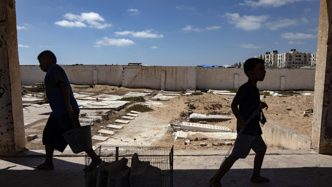 Palestinians make graves from the rubble of Gaza's destroyed homes