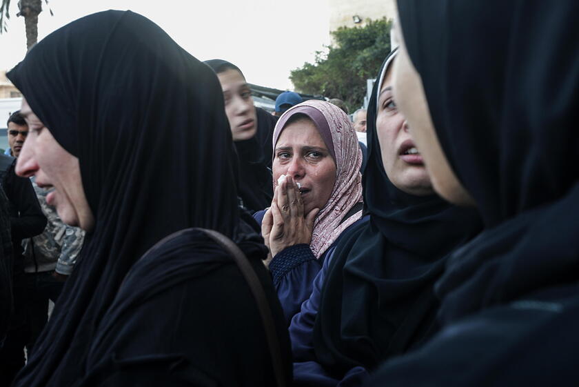 Palestinians mourn their dead at Deir Al Balah hospital after Israeli airstrike in central Gaza