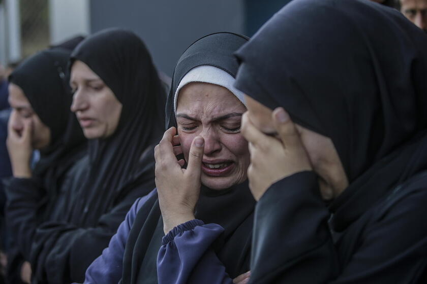 Palestinians mourn their dead at Deir Al Balah hospital after Israeli airstrike in central Gaza